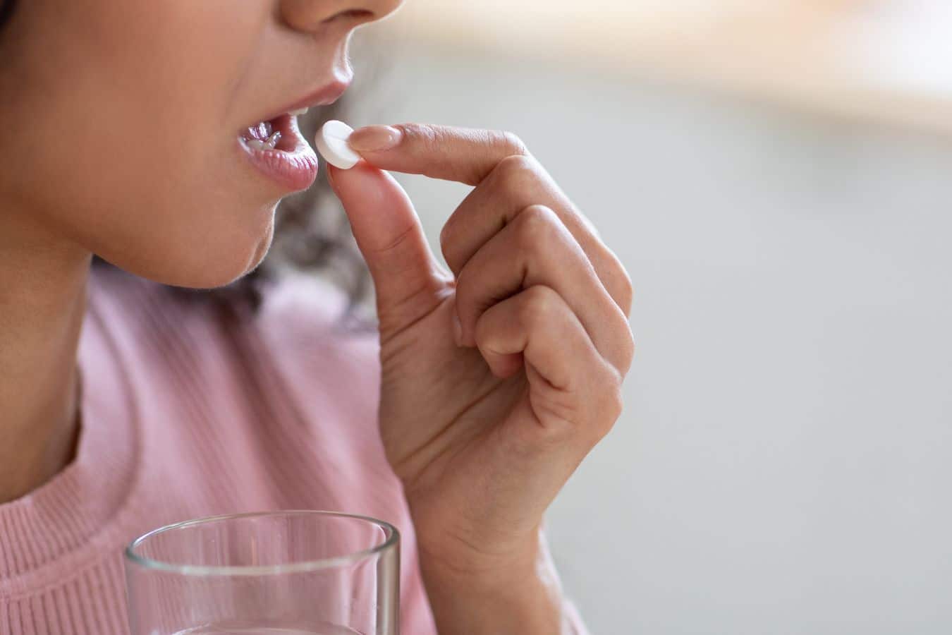 Woman taking oral probiotics for improved dental health dentist in sandy ut